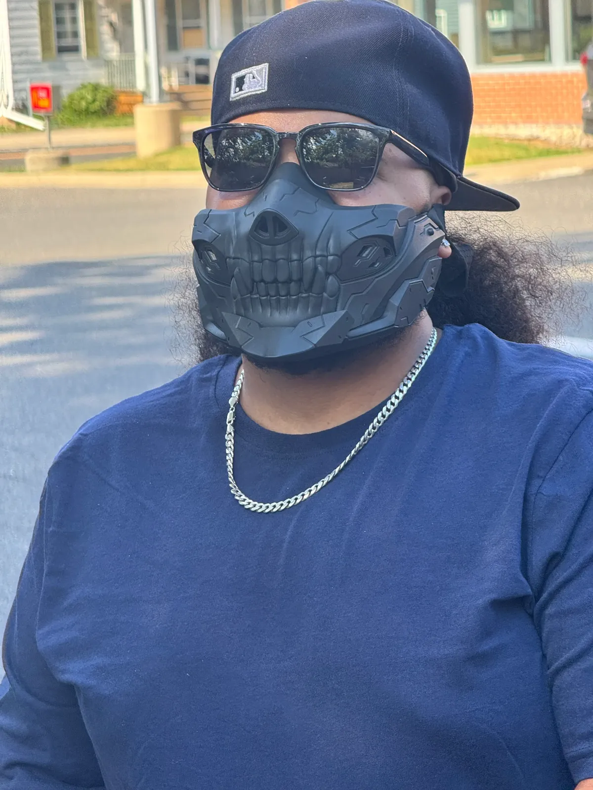 Rider wearing a black skull mask and backwards cap outdoors