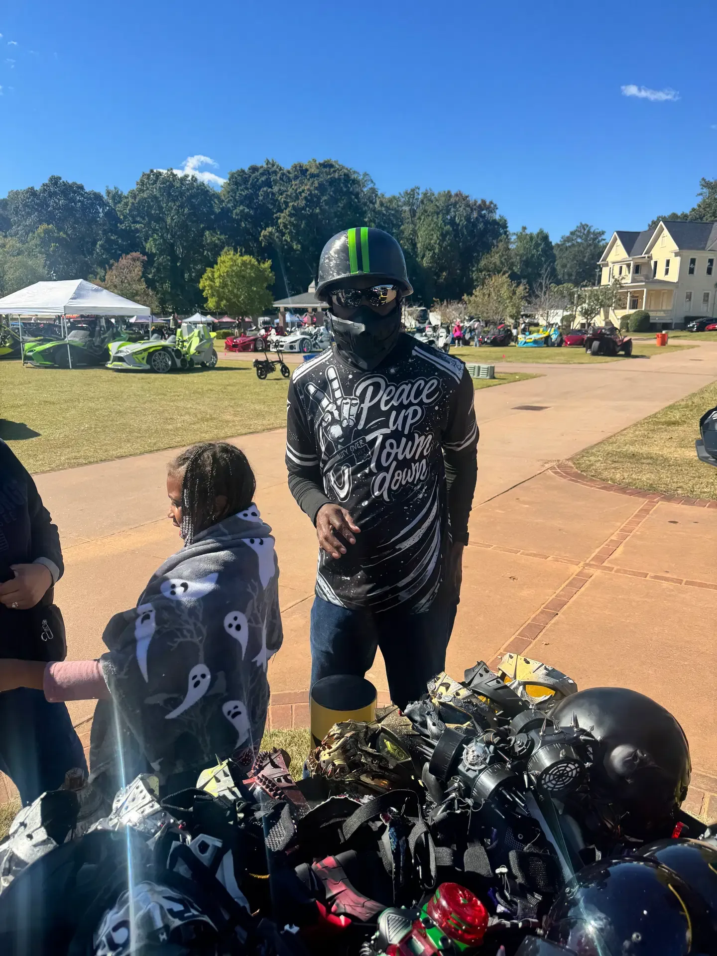 Rider wearing a dark helmet and face covering at the 3WK event