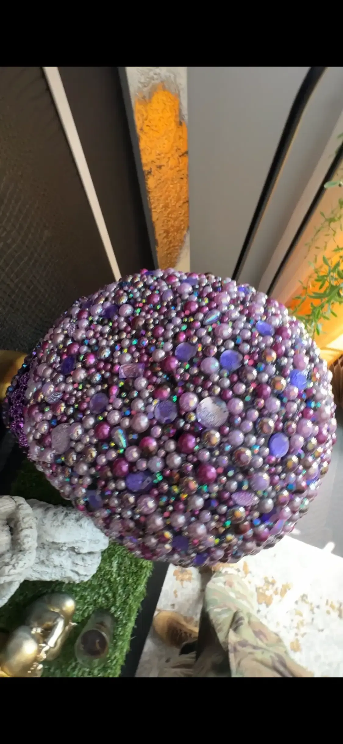 Original photo detail of the purple crystal-embellished ball-cap helmet
