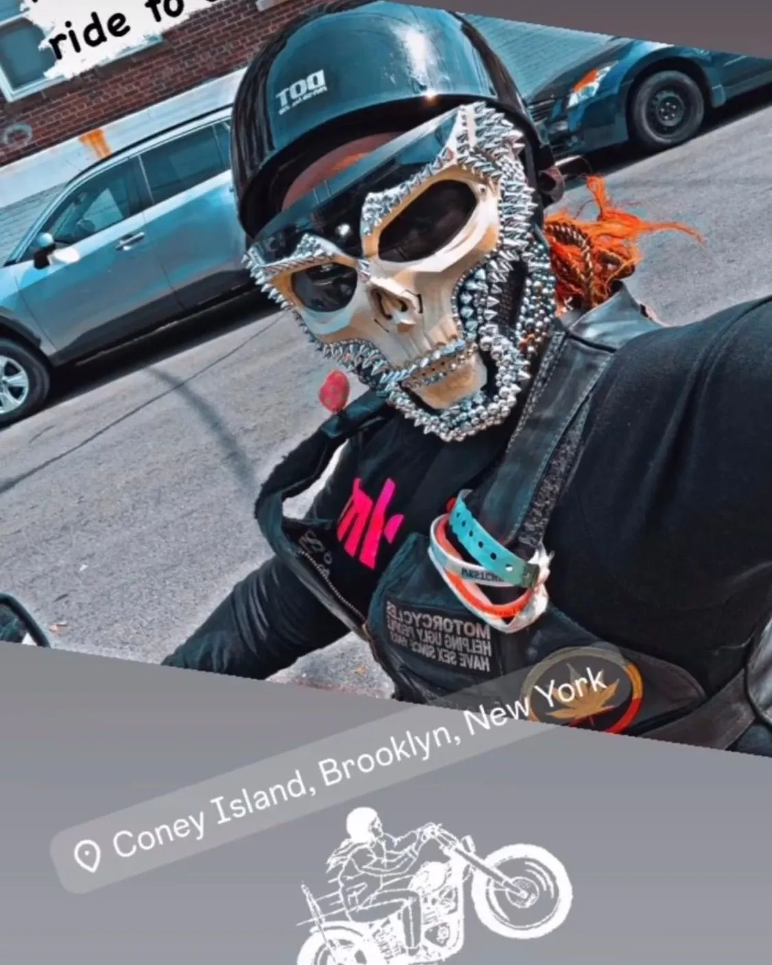 FAB N THINGZ rider in a crystal-encrusted silver full-face helmet with a green mohawk strip
